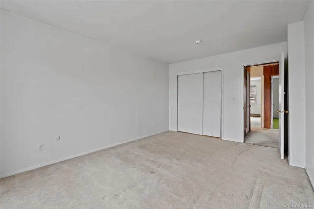 a bathroom with a granite countertop toilet sink and mirror