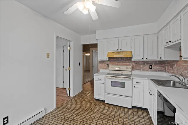 a kitchen with a sink cabinets and stainless steel appliances