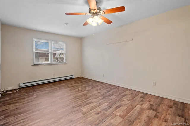 wooden floor in an empty room with a window