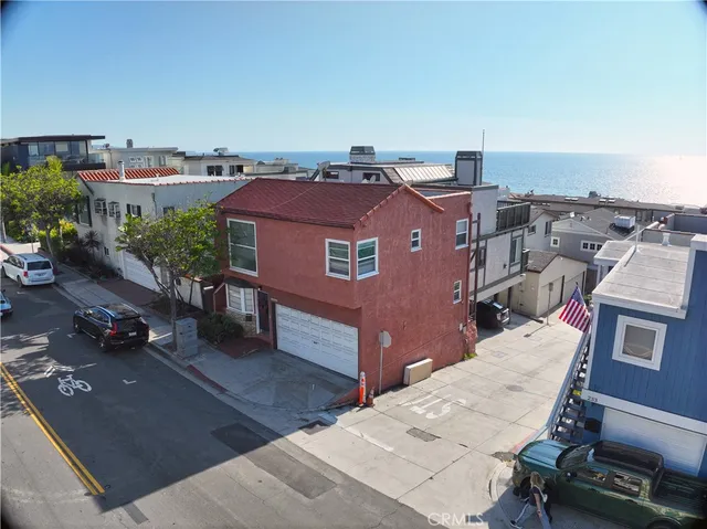 an aerial view of a house with a yard garage table and chairs