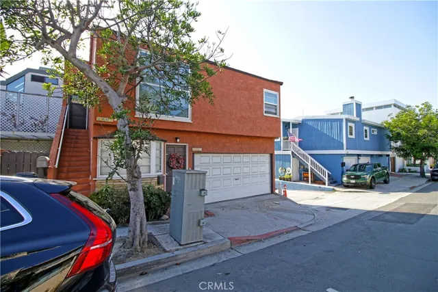 a view of a house with a small yard and wooden fence
