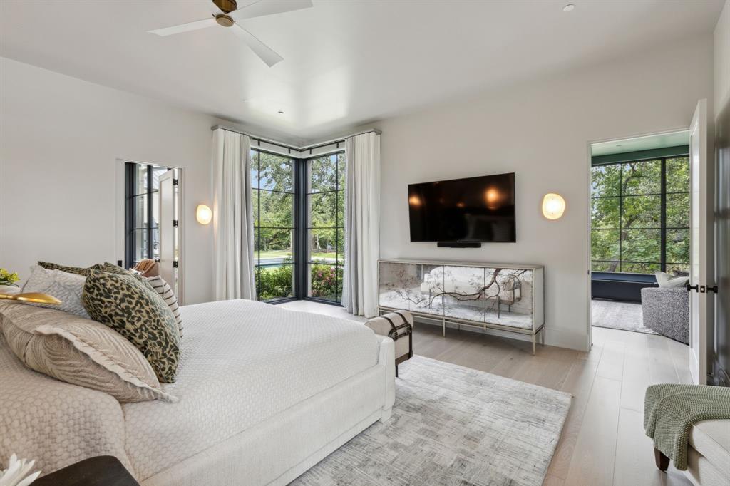 1502 Bluffview Drive Roanoke, TX 76262 - Photo 13 of 34 a bedroom with a bed couches and a flat screen tv