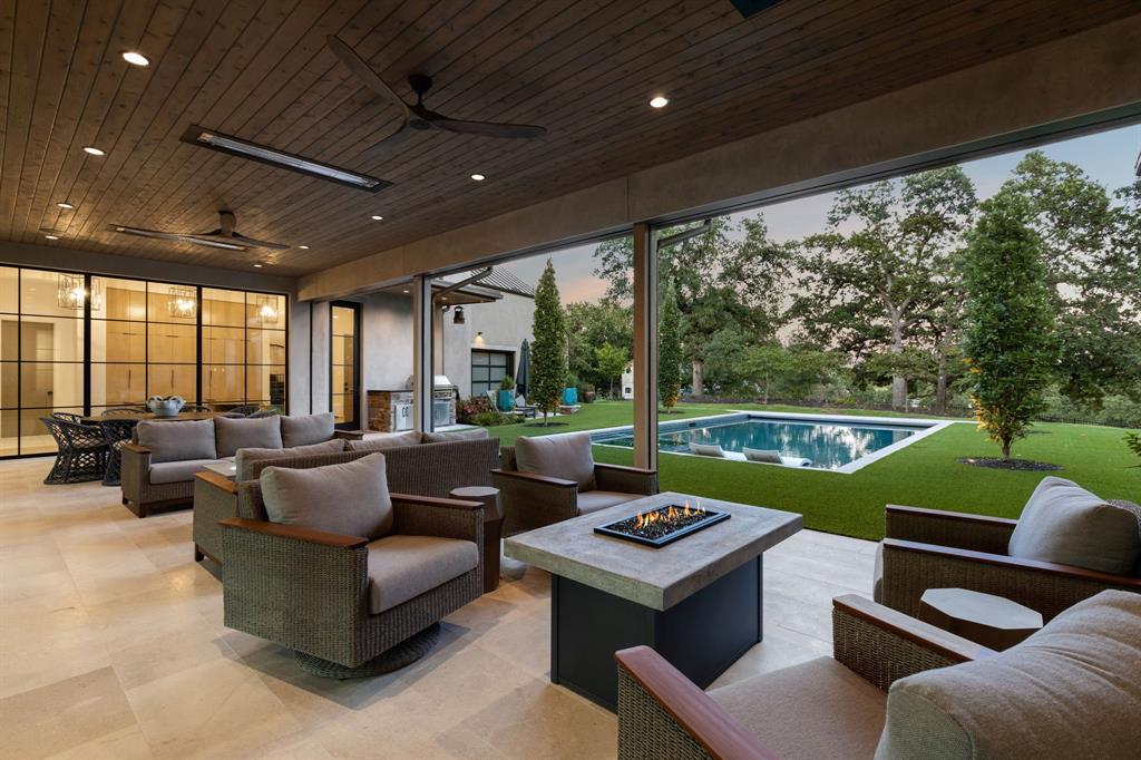 1502 Bluffview Drive Roanoke, TX 76262 - Photo 31 of 34 a living room with patio furniture and a garden