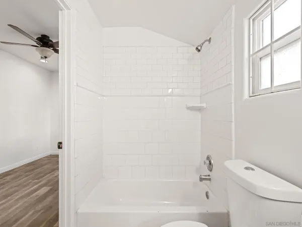 a bathroom with a bathtub and a toilet