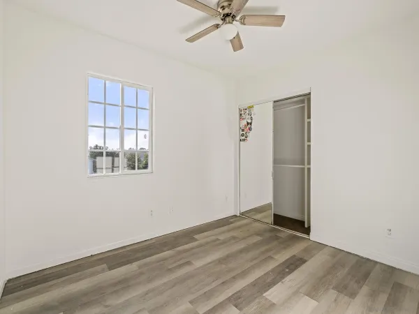 a view of a big room with wooden floor and windows in a room