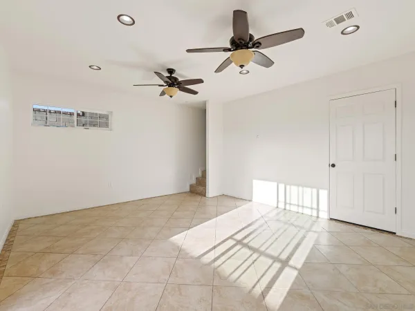 a view of a room with a ceiling fan
