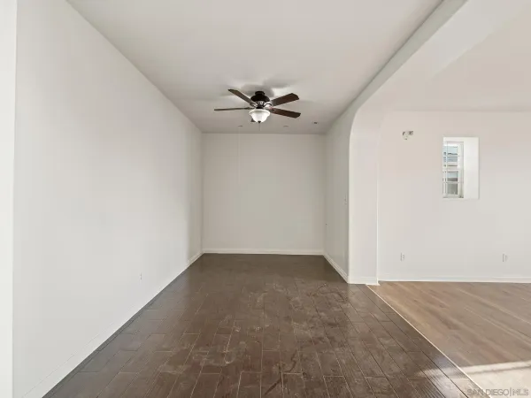 an empty room with fan and a ceiling fan