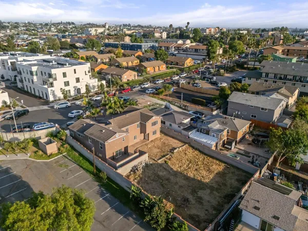an aerial view of residential houses with outdoor space