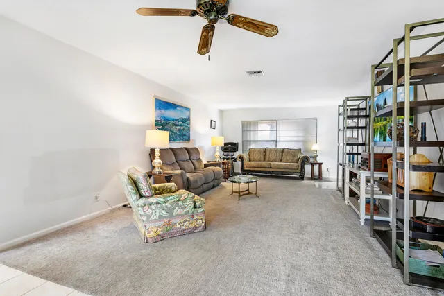 a living room with furniture and a book shelf