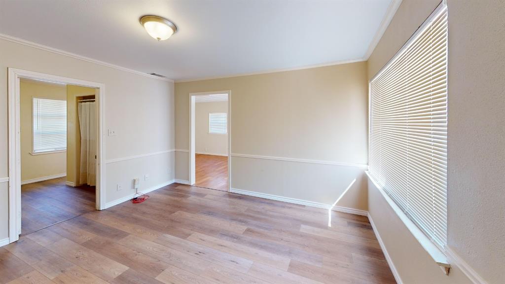 12225 Schroeder Road Dallas, TX 75243 - Photo 20 of 40 Wood-finish flooring, neutral wall tones, chair rail molding, and a flush mount ceiling light