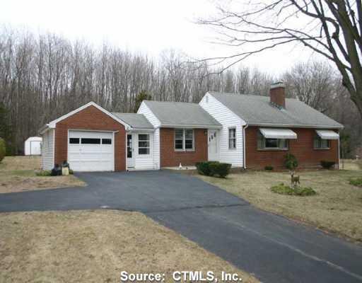 a front view of a house with a garden and yard