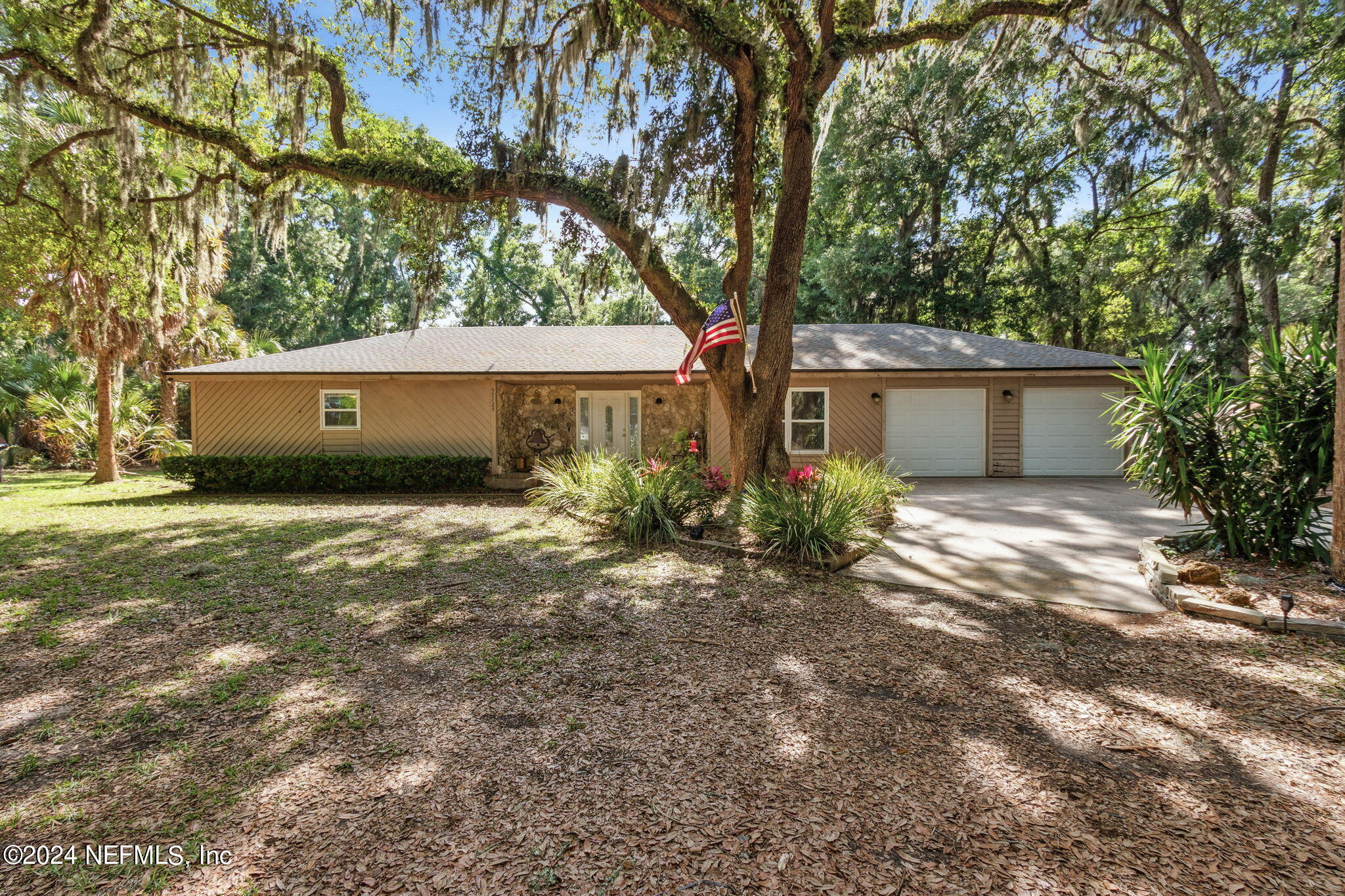 97125 Pirates Point Road Yulee, FL 32097 - Photo 1 of 90 a house that has a tree in front of it