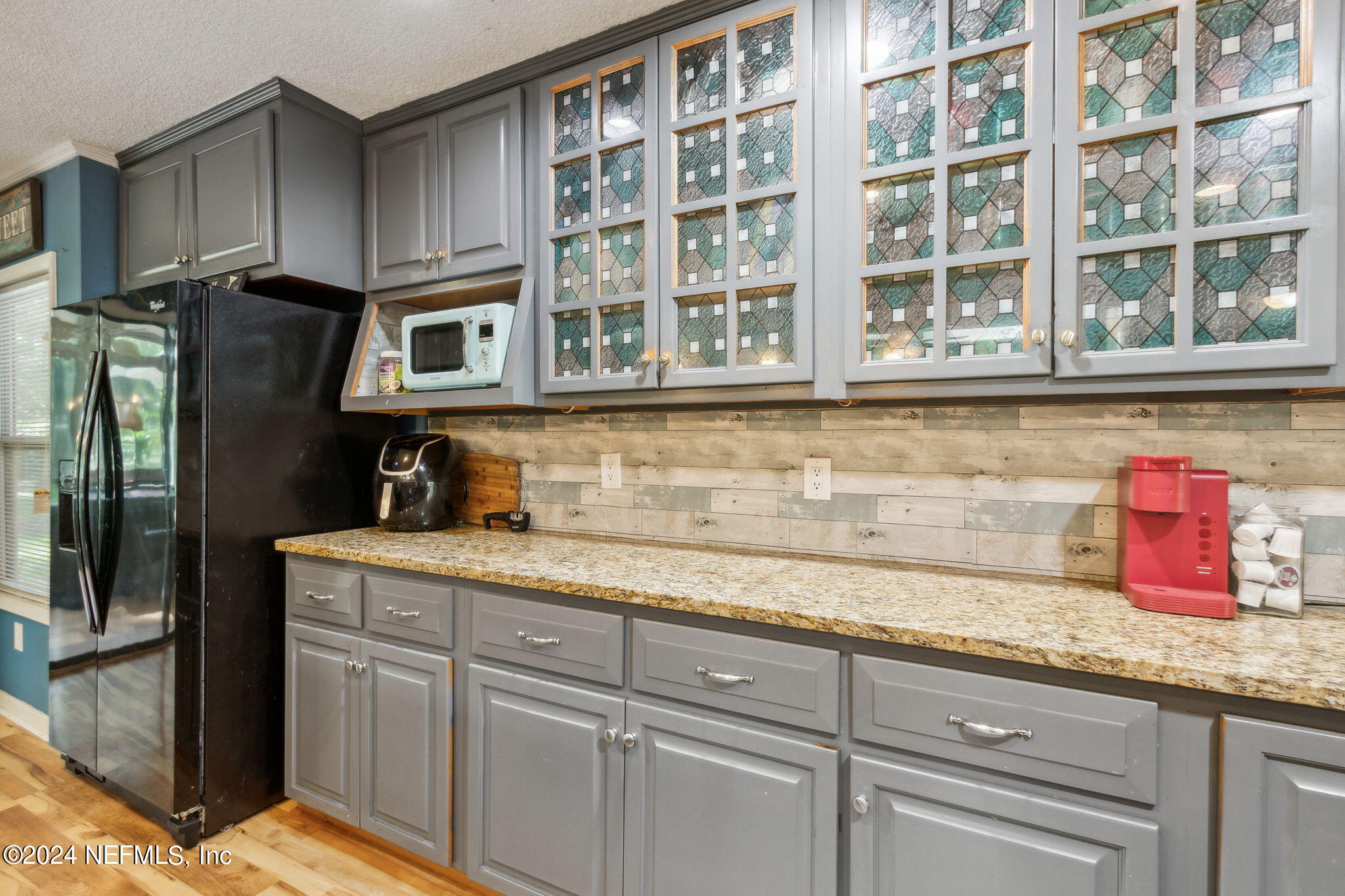 97125 Pirates Point Road Yulee, FL 32097 - Photo 21 of 90 a kitchen with granite countertop cabinets and stainless steel appliances