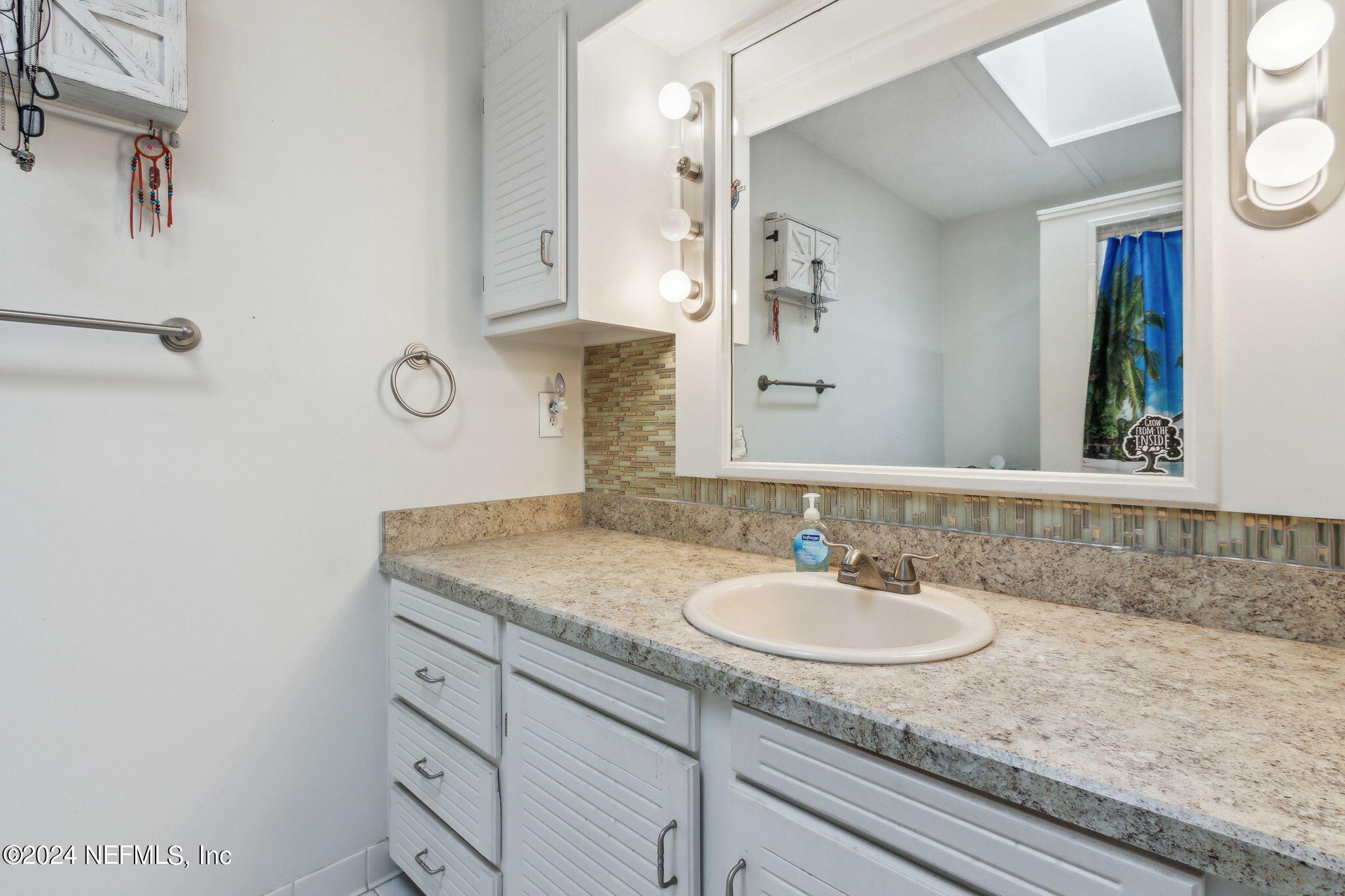 97125 Pirates Point Road Yulee, FL 32097 - Photo 4 of 90 a bathroom with a granite countertop sink and a mirror