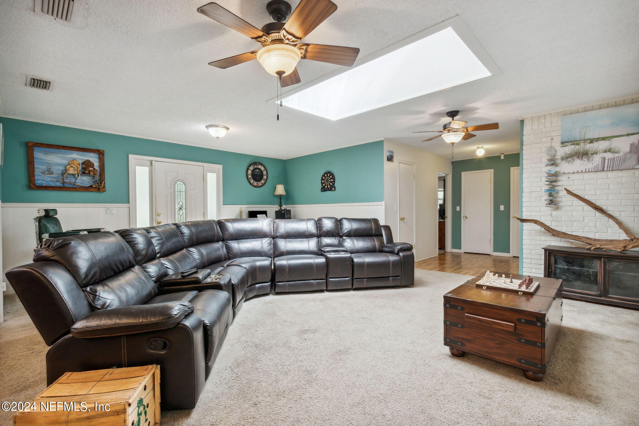 97125 Pirates Point Road Yulee, FL 32097 - Photo 5 of 90 a living room with furniture and a chandelier