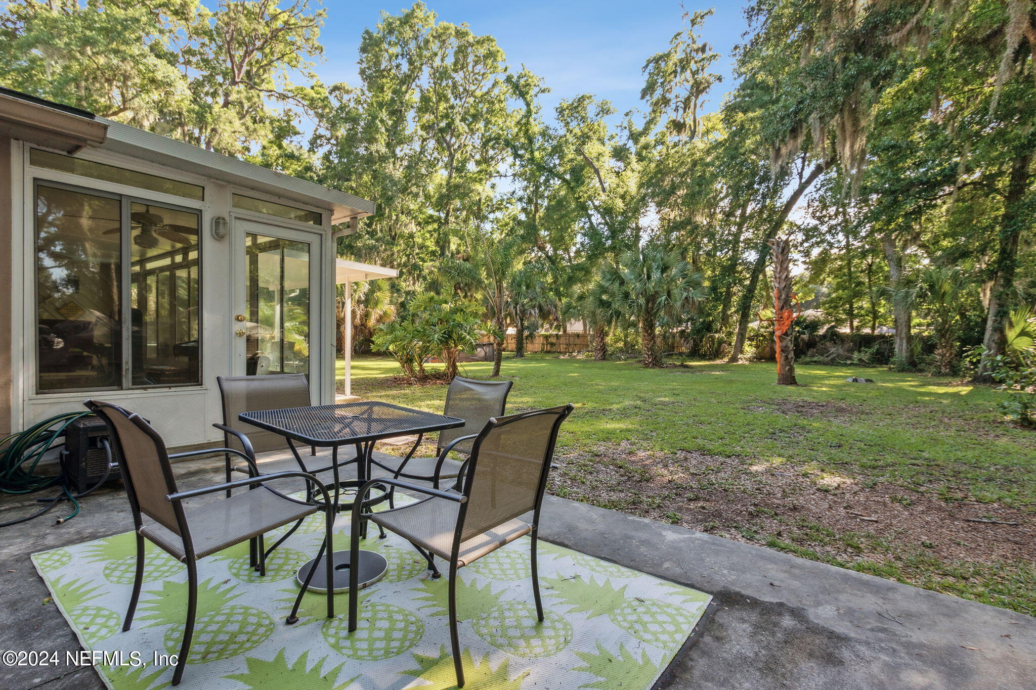 97125 Pirates Point Road Yulee, FL 32097 - Photo 51 of 90 a view of a house with backyard and sitting area