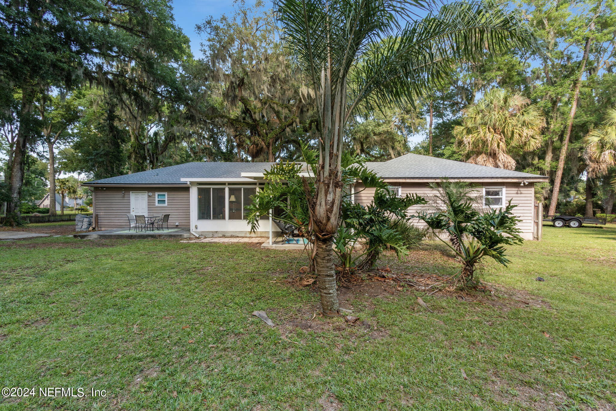 97125 Pirates Point Road Yulee, FL 32097 - Photo 54 of 90 a view of a house with a backyard
