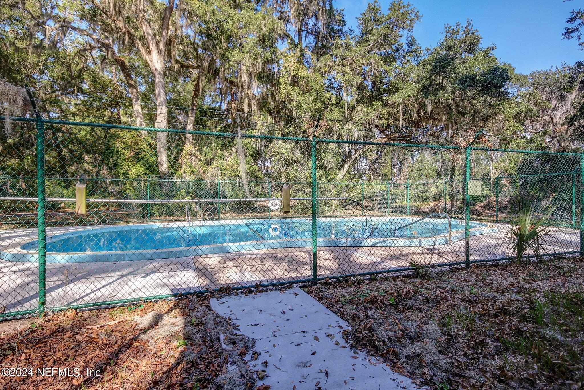 97125 Pirates Point Road Yulee, FL 32097 - Photo 84 of 90 a view of a backyard with wooden fence