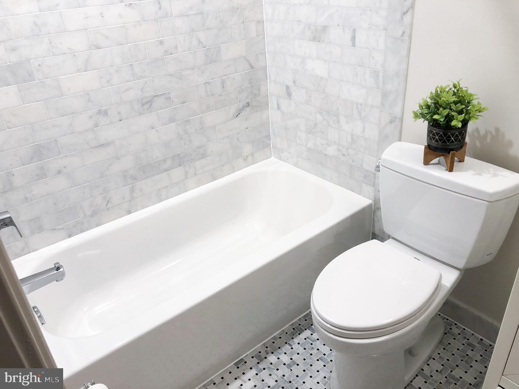 1302 East Capitol Street Northeast, Unit B Washington, DC 20003 - Photo 11 of 23 a white toilet sitting next to a bath tub