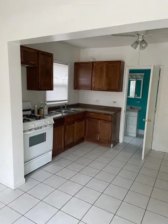 a kitchen with a sink a stove and cabinets
