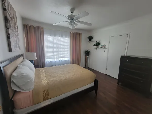 a bedroom with a bed and a dresser