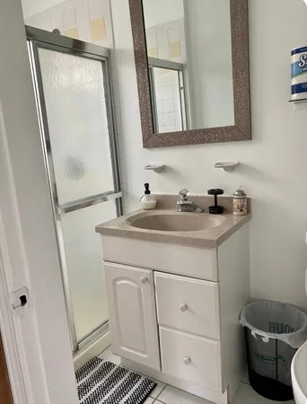 a bathroom with a sink a toilet and a mirror