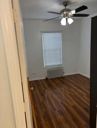 a view of a livingroom with a ceiling fan and window
