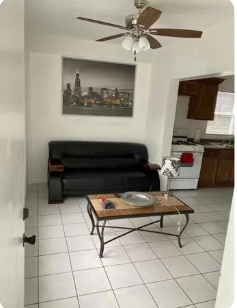 a living room with furniture and a dresser
