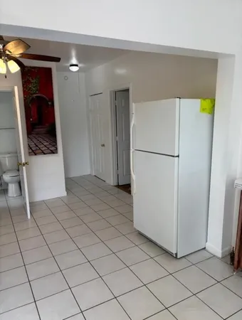 a view of a refrigerator and storage in a room