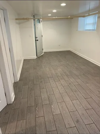 en empty room with wooden floor and white walls