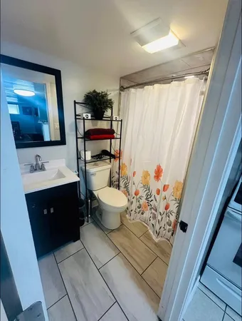 a bathroom with a sink toilet and shower
