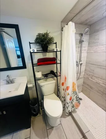 a bathroom with a sink toilet and shower