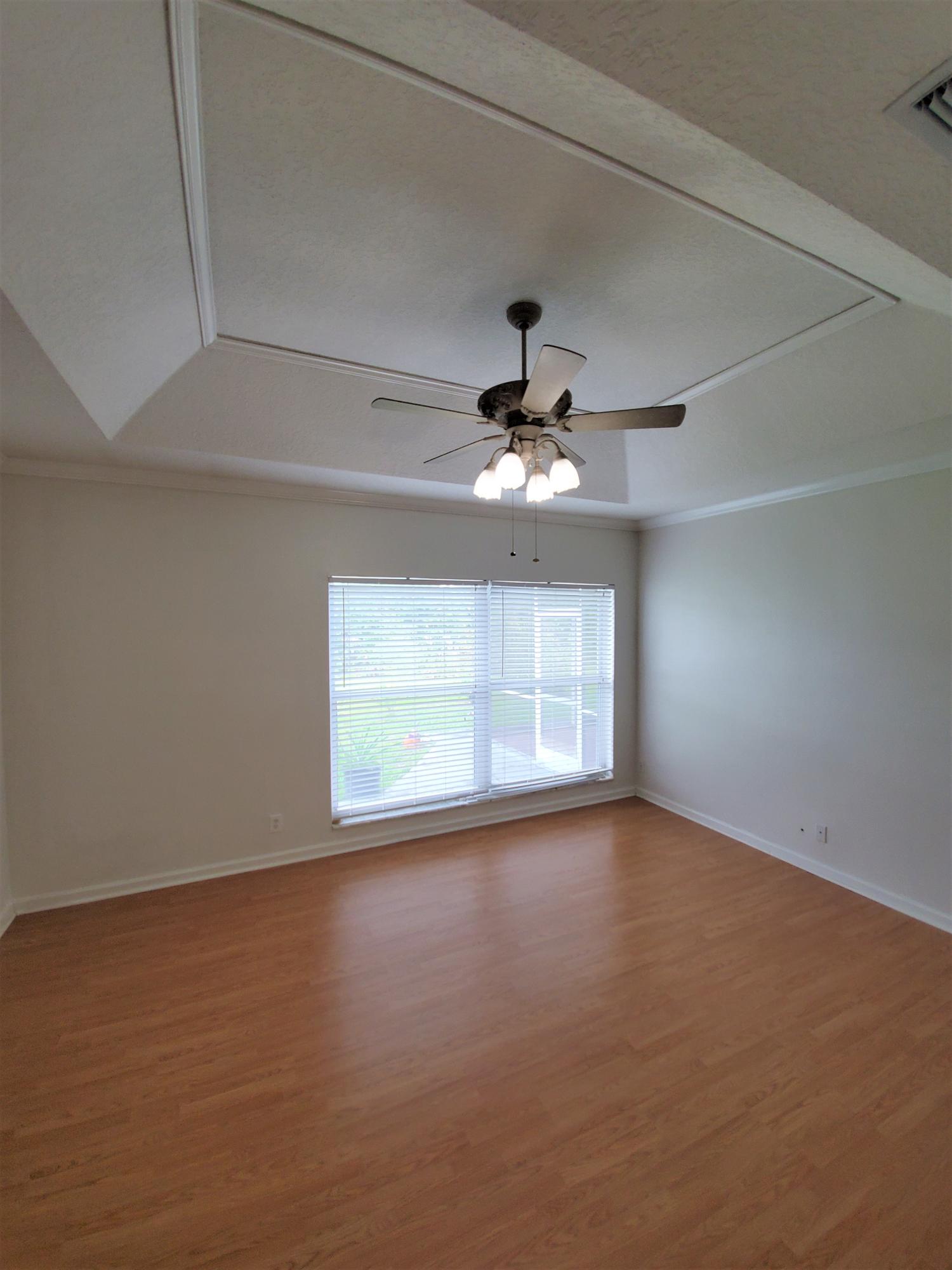 9897 Sandy Run Road Jupiter, FL 33478 - Photo 13 of 30 an empty room with a window and a ceiling fan