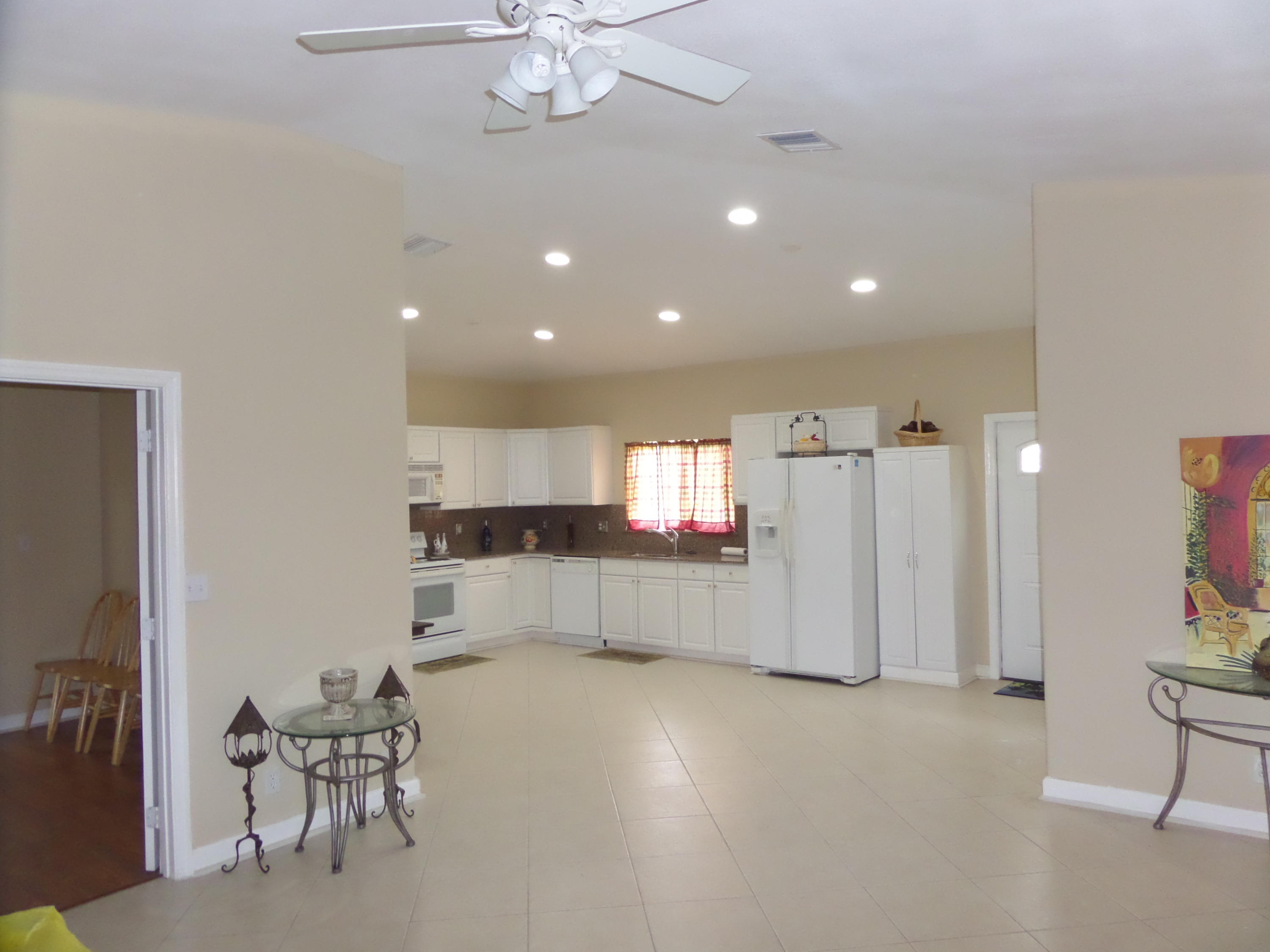 9897 Sandy Run Road Jupiter, FL 33478 - Photo 15 of 30 a view of kitchen with furniture and chandelier
