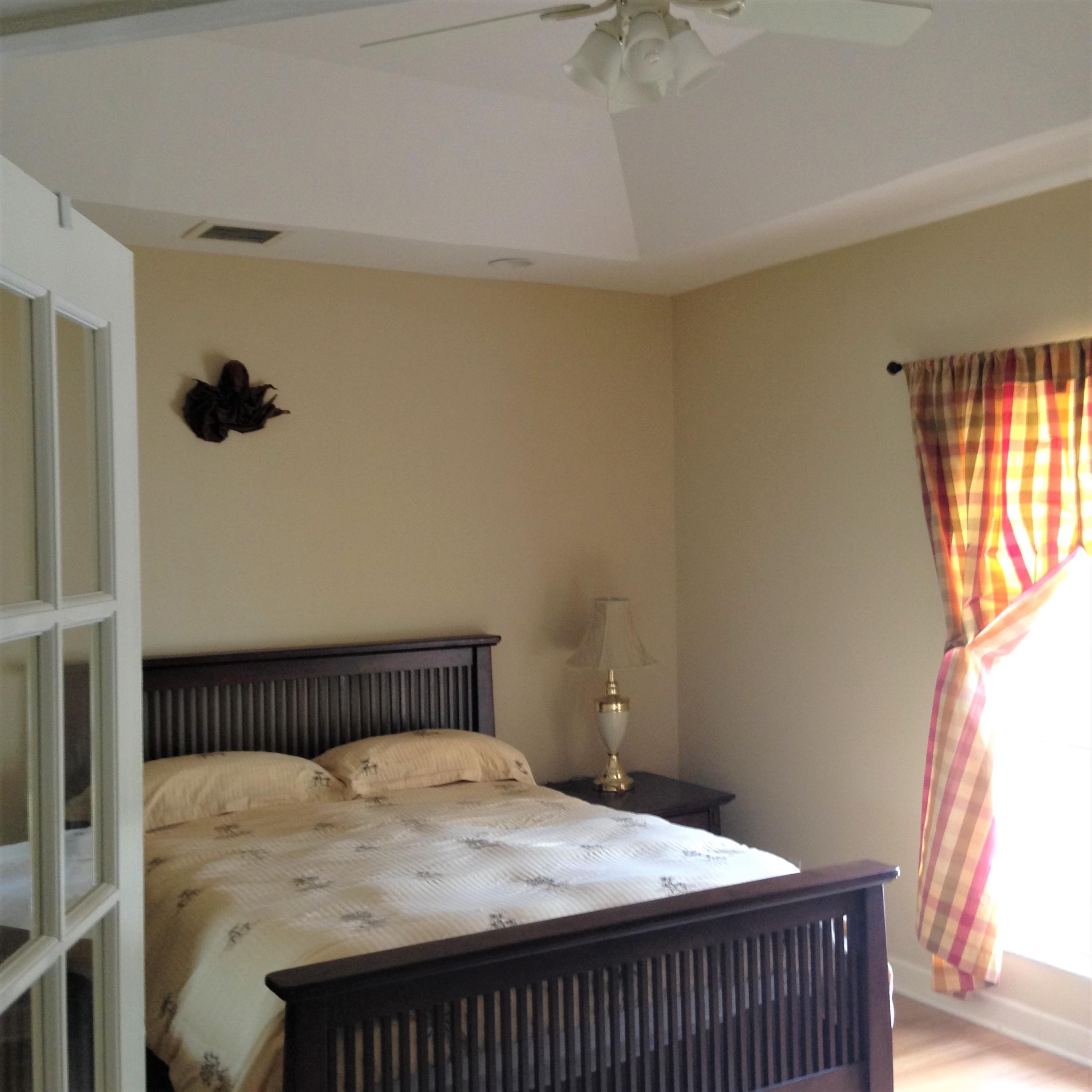 9897 Sandy Run Road Jupiter, FL 33478 - Photo 17 of 30 a bedroom with a bed and wooden floor