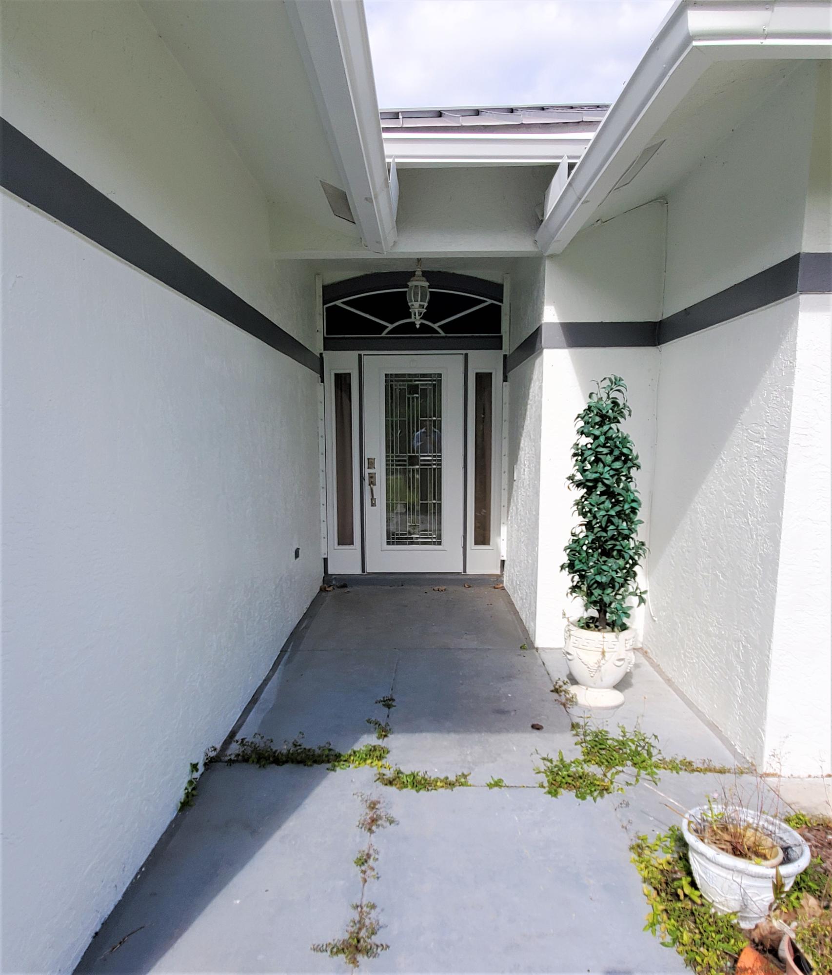 9897 Sandy Run Road Jupiter, FL 33478 - Photo 19 of 30 a front view of a house with plants