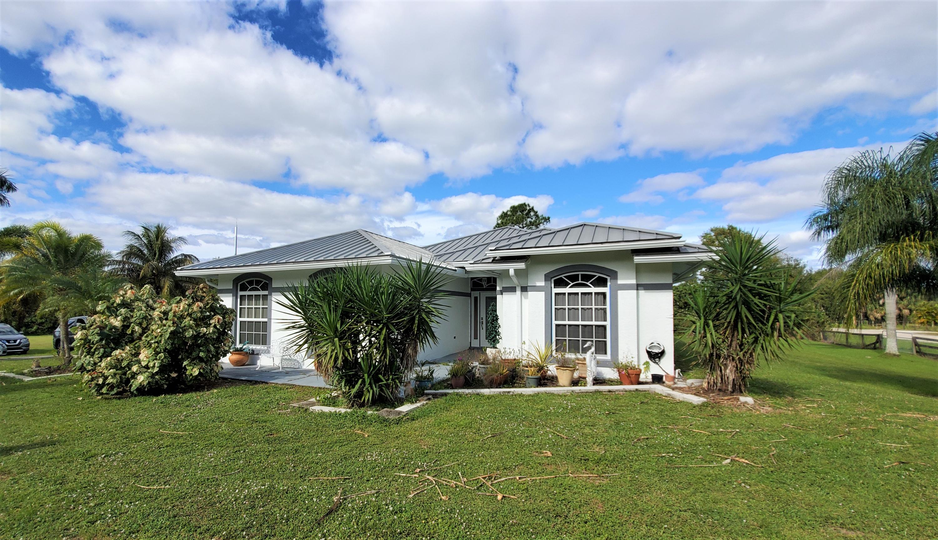 9897 Sandy Run Road Jupiter, FL 33478 - Photo 20 of 30 a front view of house with yard and green space