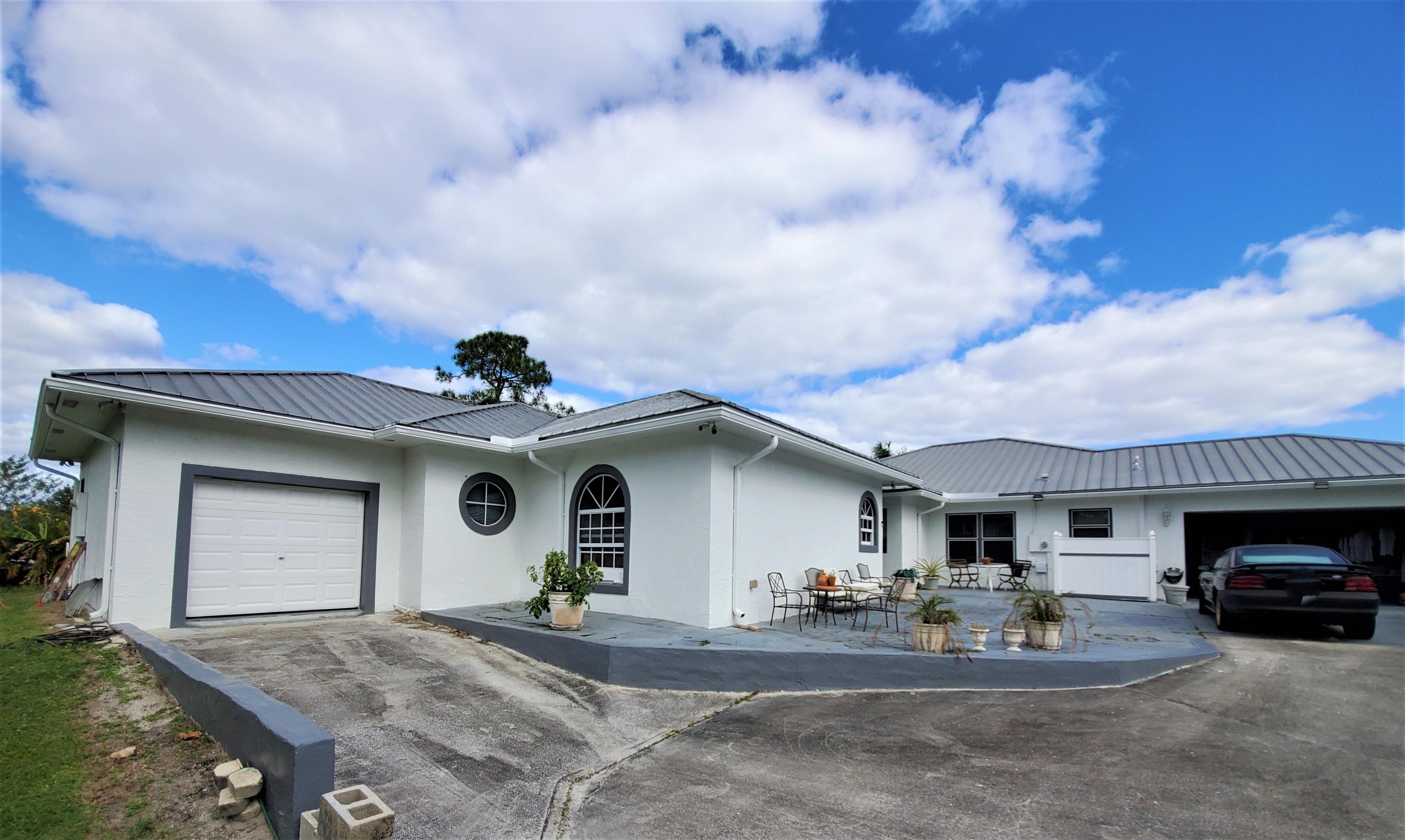 9897 Sandy Run Road Jupiter, FL 33478 - Photo 2 of 30 a view of house and outdoor space
