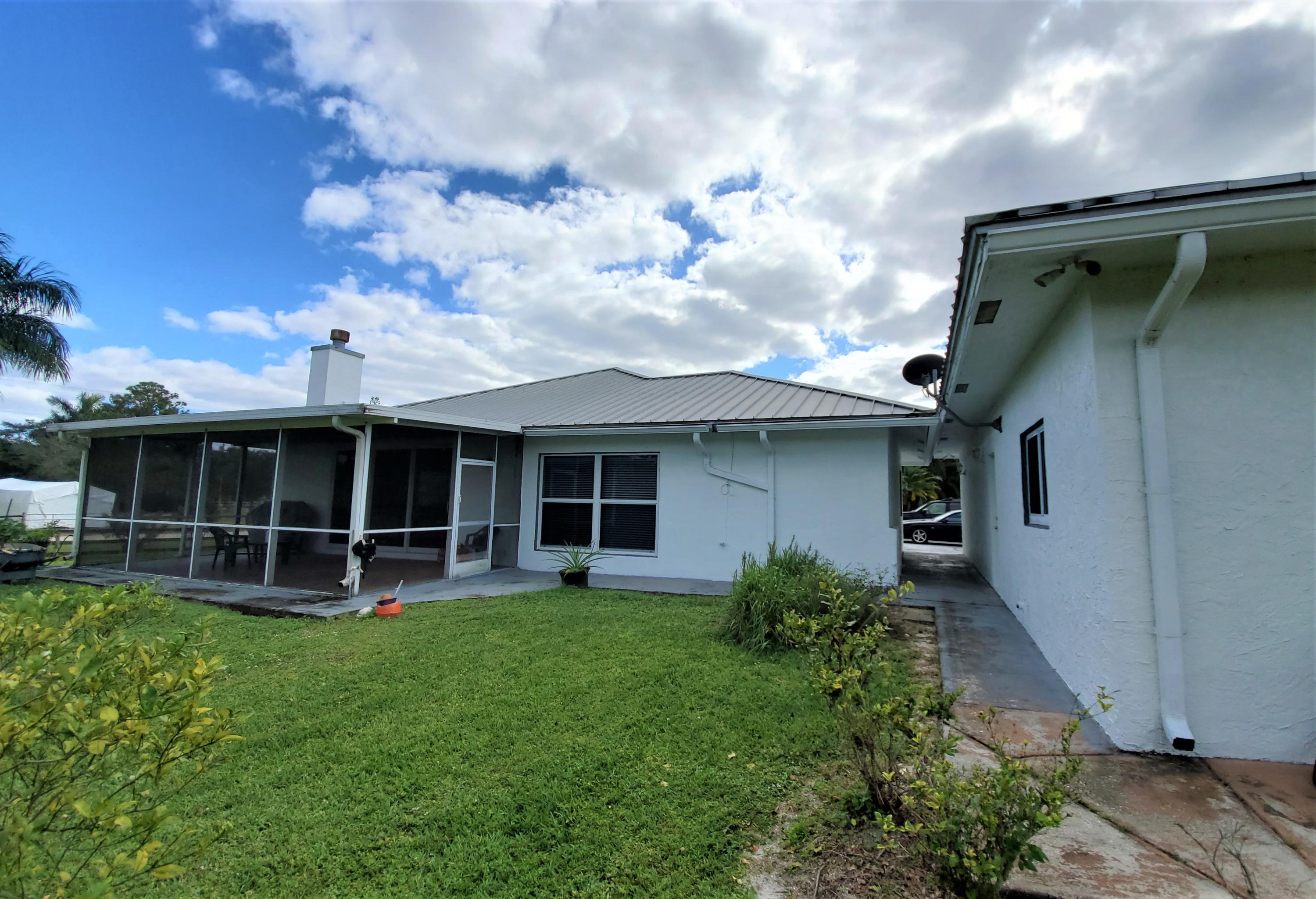 9897 Sandy Run Road Jupiter, FL 33478 - Photo 21 of 30 a view of a house with roof and sitting area