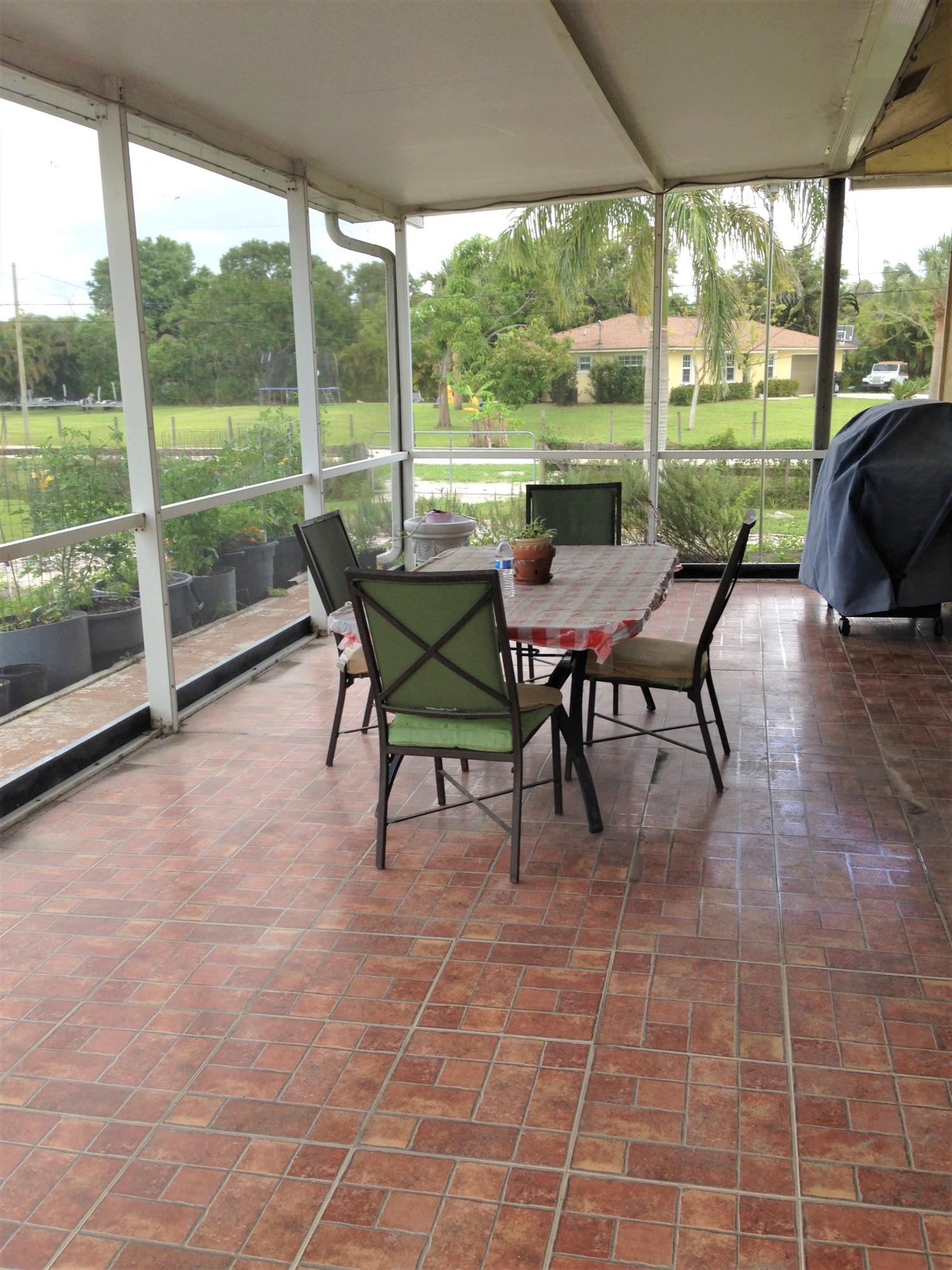9897 Sandy Run Road Jupiter, FL 33478 - Photo 22 of 30 a view of a big yard with furniture and garden view