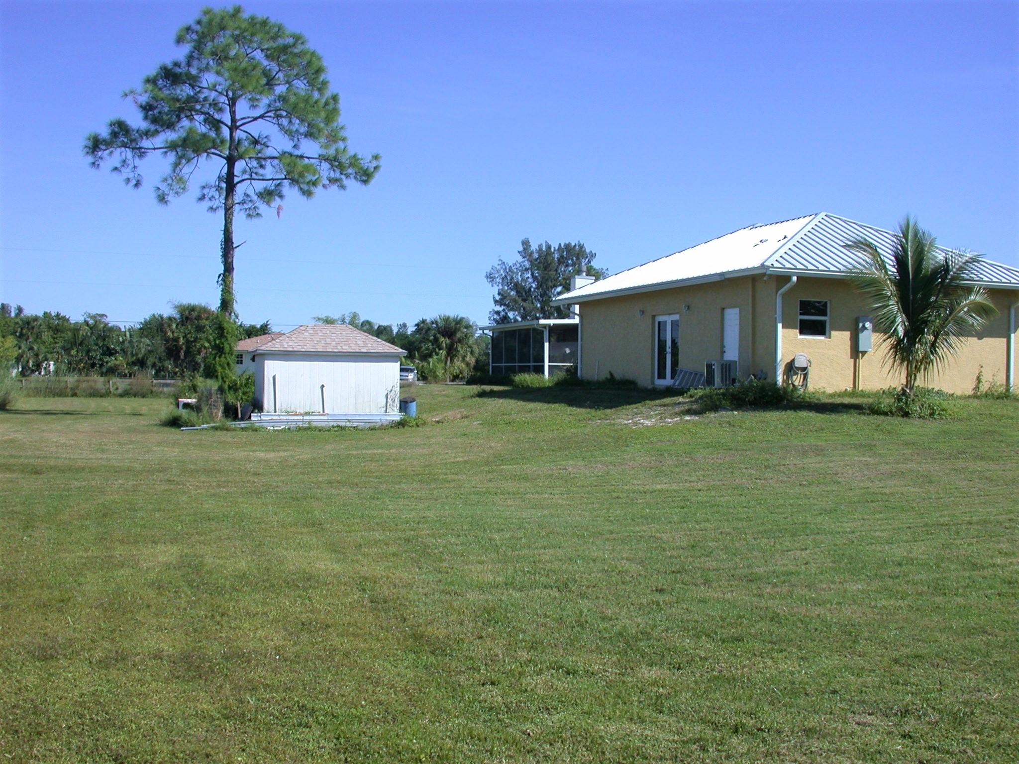 9897 Sandy Run Road Jupiter, FL 33478 - Photo 25 of 30 a front view of a house with garden