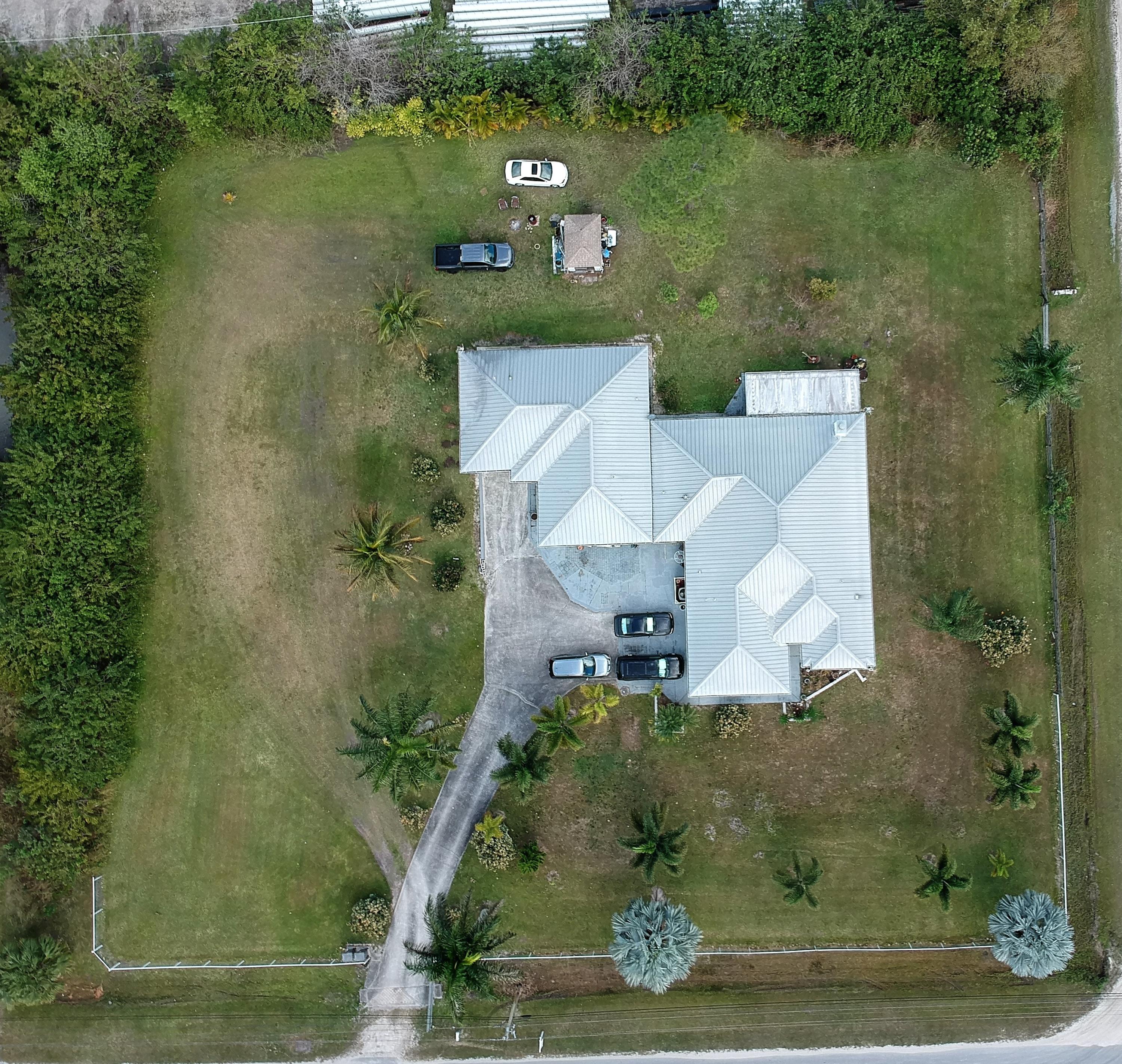 9897 Sandy Run Road Jupiter, FL 33478 - Photo 27 of 30 an aerial view of a house with a yard and lake view