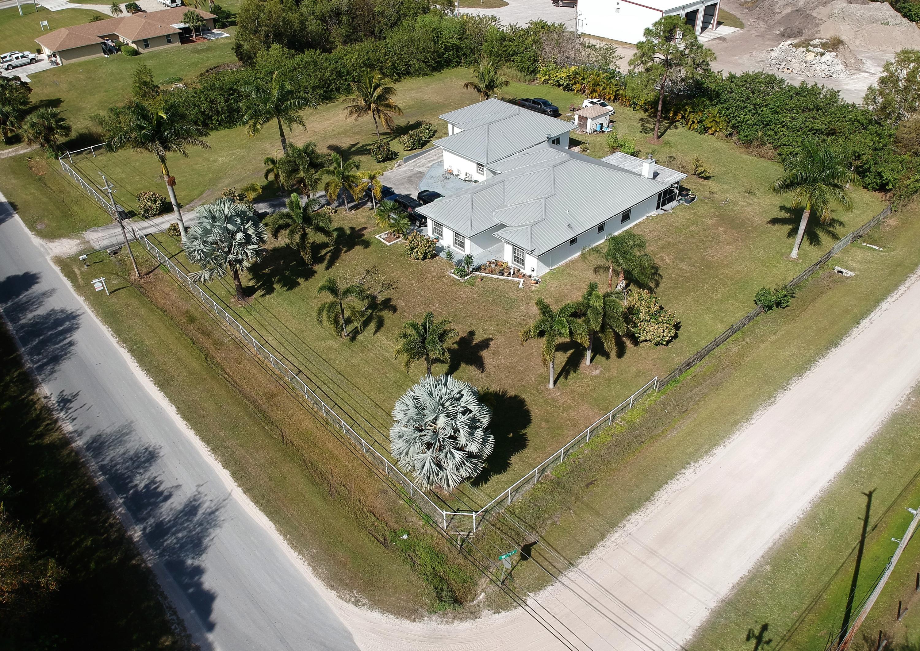 9897 Sandy Run Road Jupiter, FL 33478 - Photo 29 of 30 a view of a swimming pool with a yard and potted plants