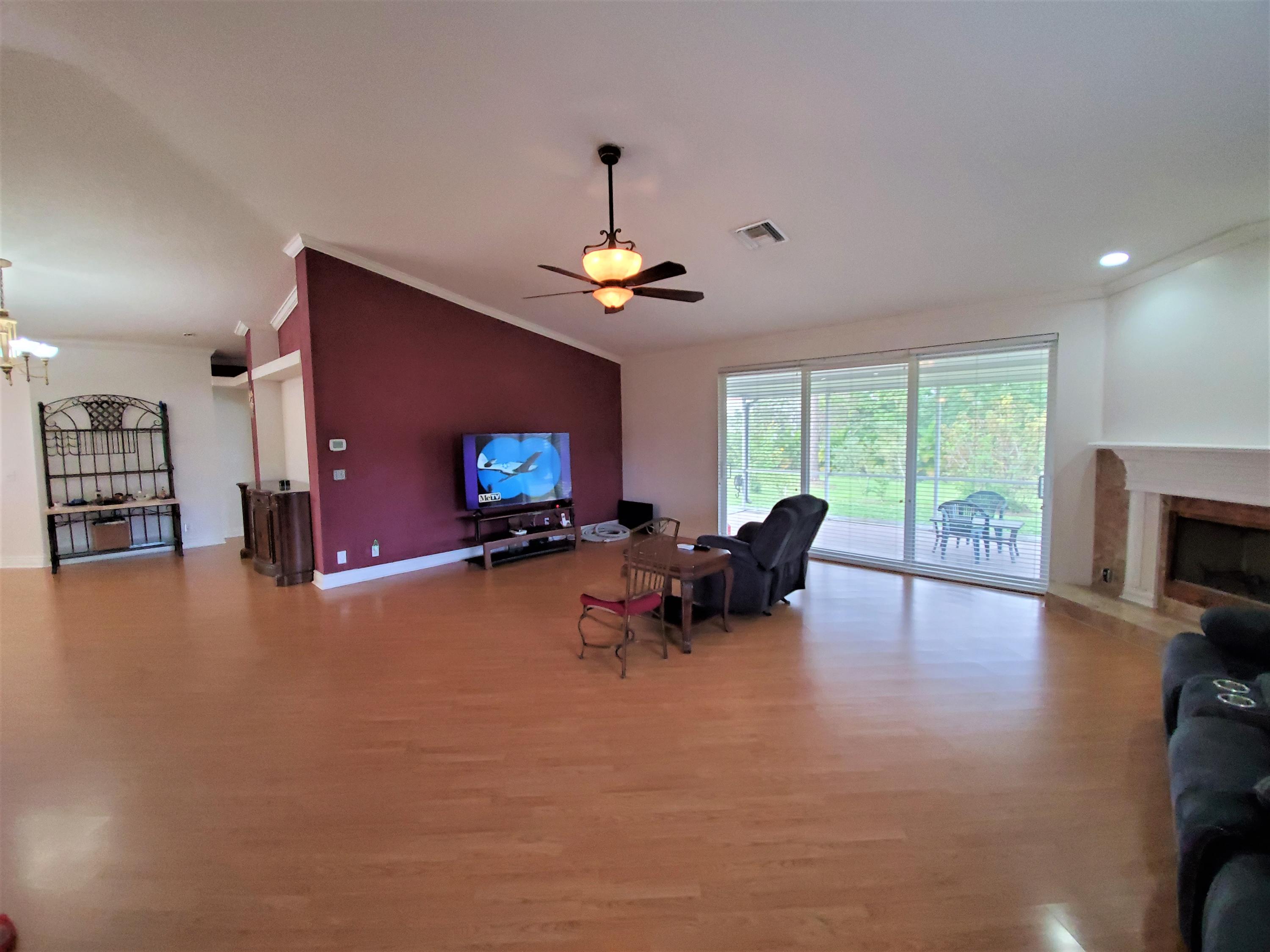 9897 Sandy Run Road Jupiter, FL 33478 - Photo 6 of 30 a living room with furniture and a fireplace