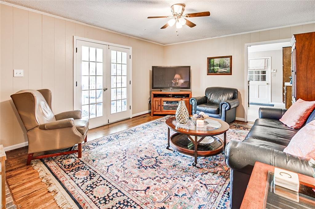 Den, hardwood floor, opens to screened porch
