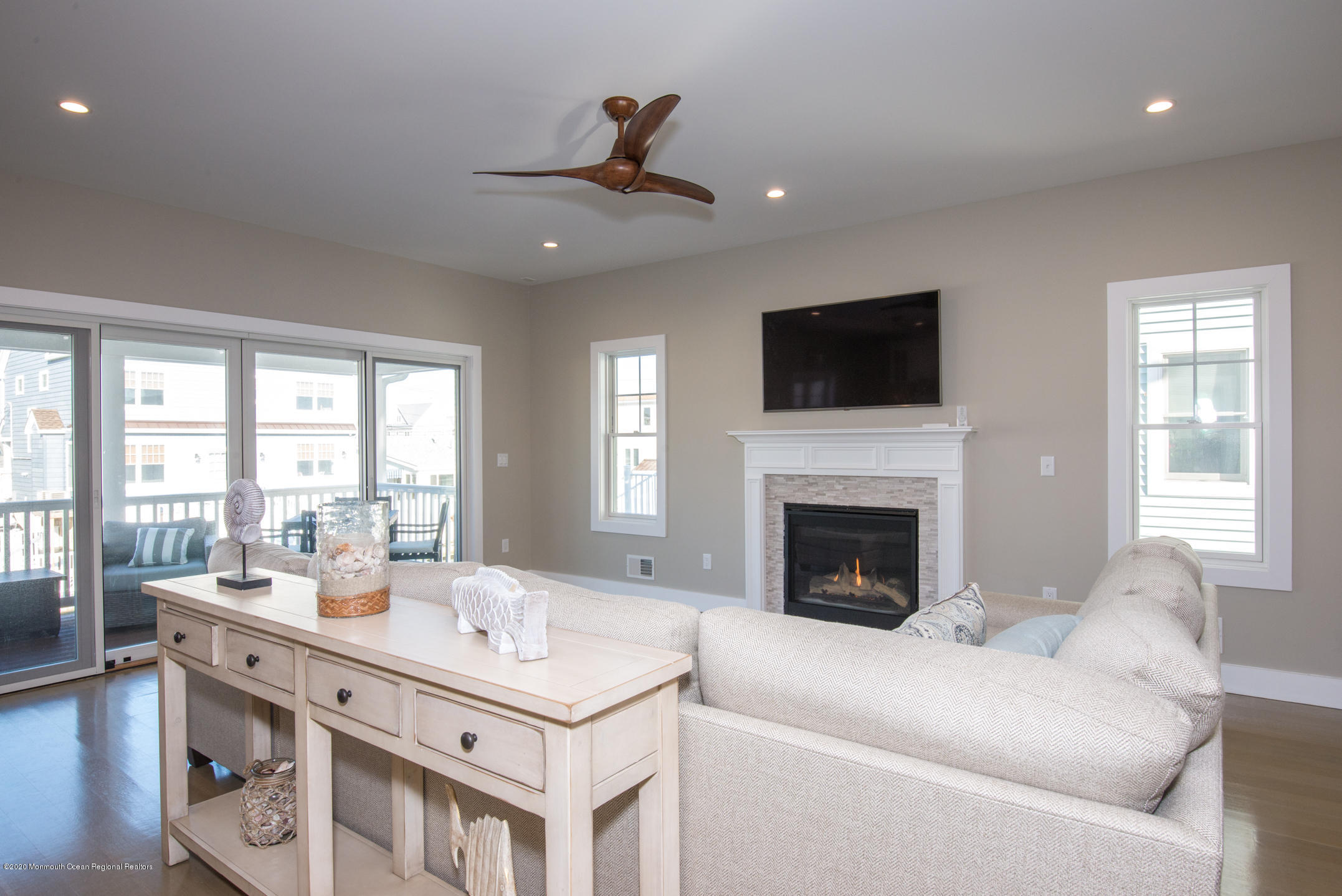 210 Johnson Road Lavallette, NJ 08735 - Photo 11 of 48 a living room with a fireplace furniture a flat screen tv and a large window