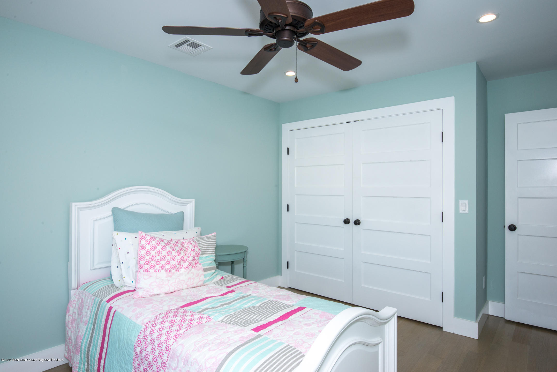 210 Johnson Road Lavallette, NJ 08735 - Photo 32 of 48 a bedroom with a bed and a chandelier