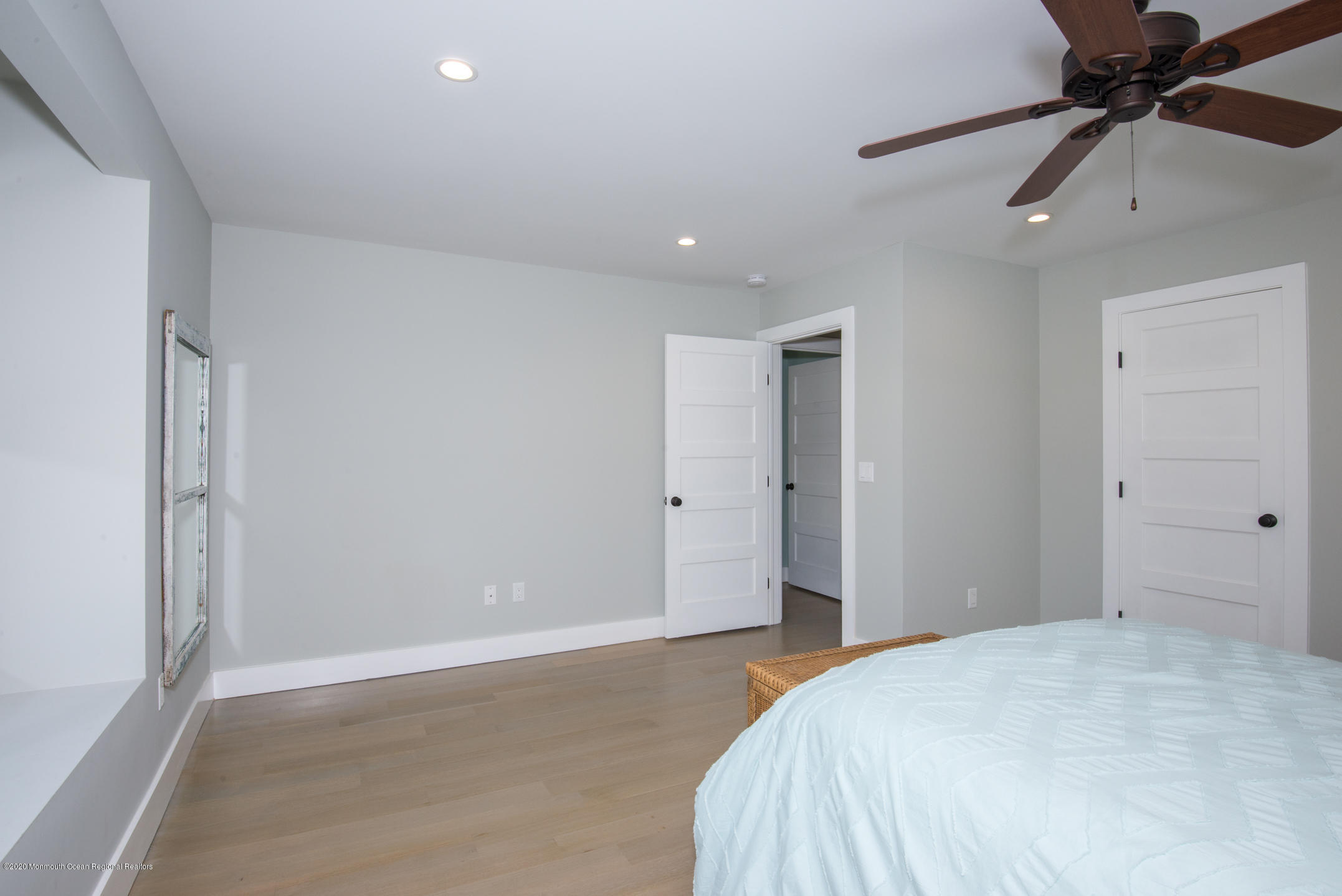 210 Johnson Road Lavallette, NJ 08735 - Photo 34 of 48 a bedroom with a bed and a chandelier fan