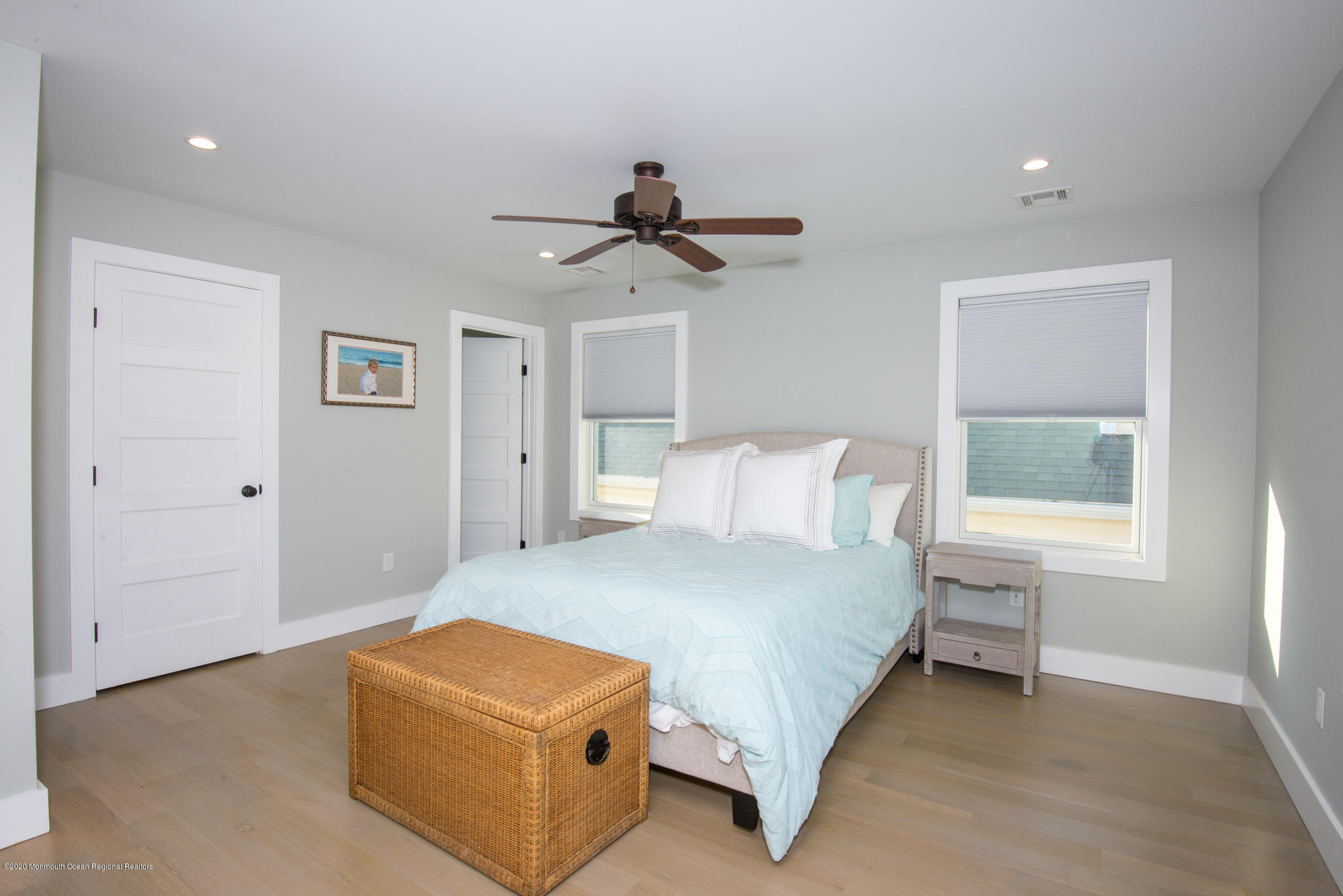 210 Johnson Road Lavallette, NJ 08735 - Photo 35 of 48 a bedroom with a bed and a chandelier