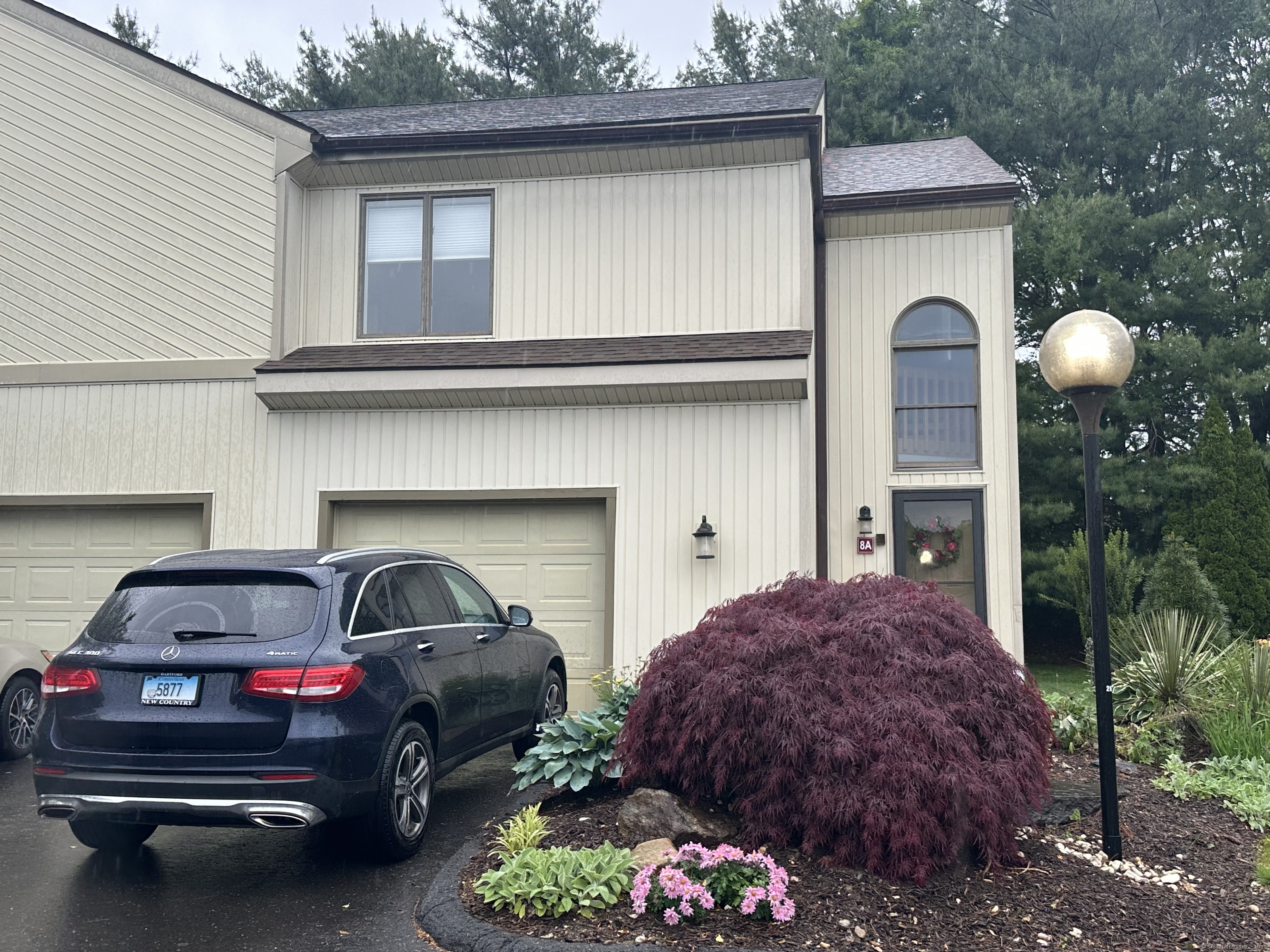 a front view of a house with parking space